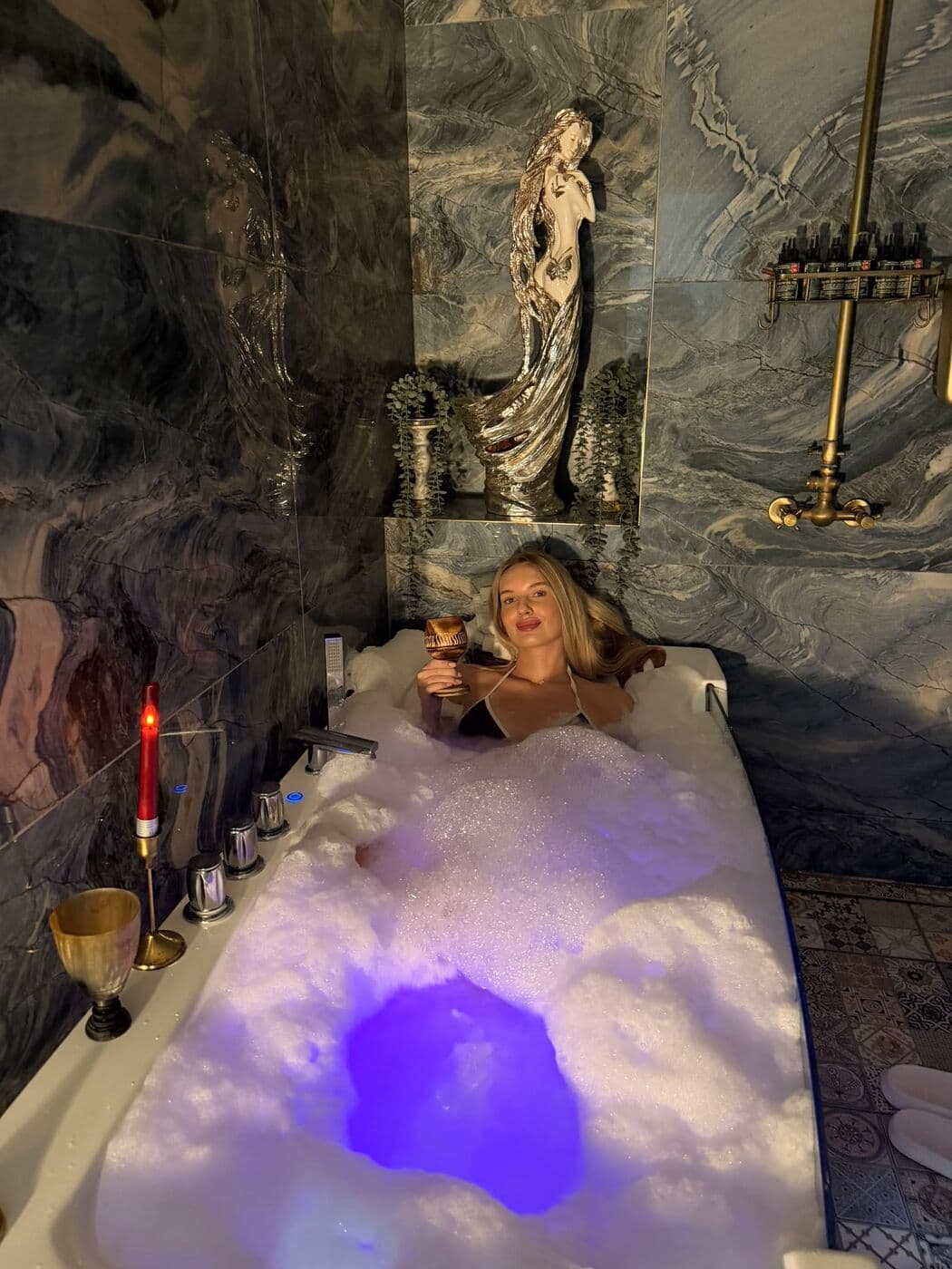 Foam treatment on a hammam table under blue light