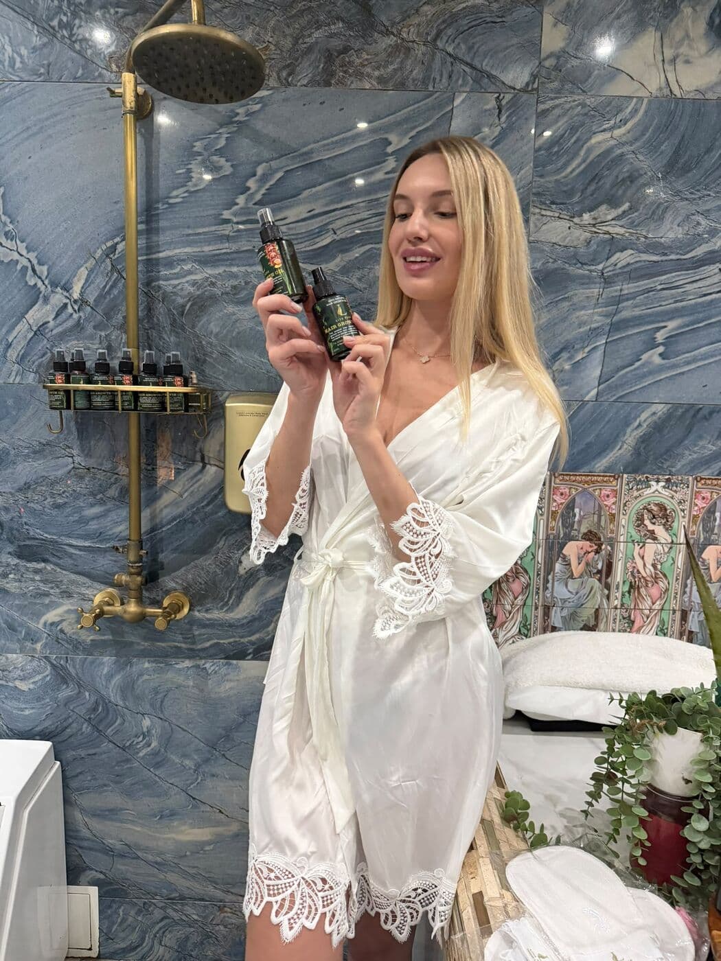 Guest in a white robe in the hammam suite