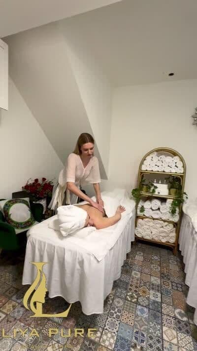 Female therapist massaging a guest during an Ethiopian body treatment at Liya Pure